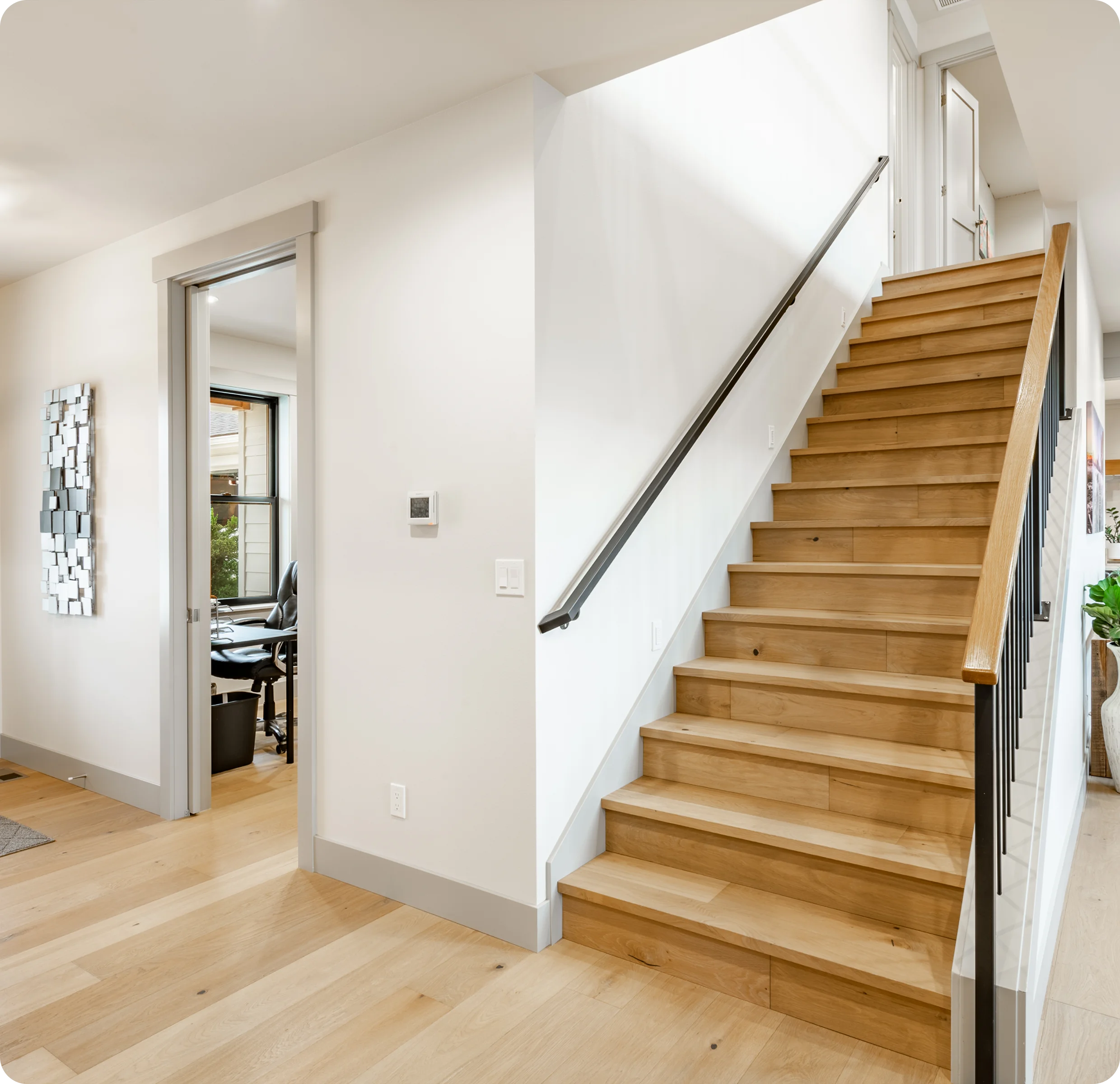 Modern interior with wooden staircase and hallway.