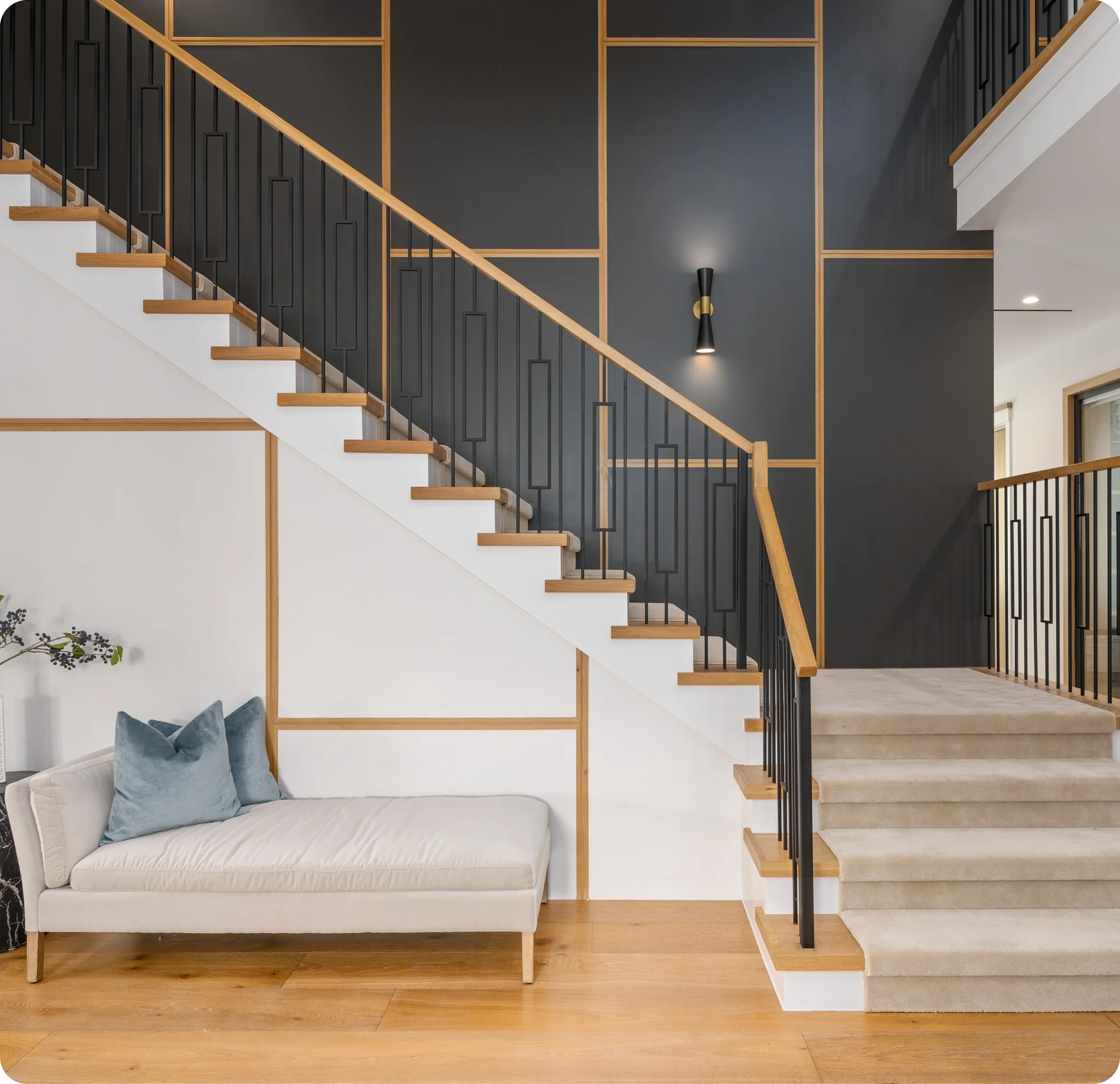 Modern staircase with geometric wall design.